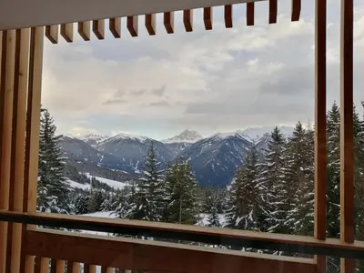 a window with a view of a snowy mountain at Oberhauser Hütte Rodenecker - Lüsner Alm in Luson