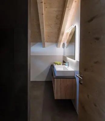 a bathroom with a sink and a mirror at Les Pizades in San Cassiano