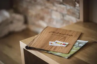 a notebook sitting on top of a wooden table at Autentis in Rasùn di Sotto