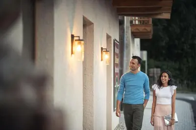 a man and a woman walking down a street at Autentis in Rasùn di Sotto