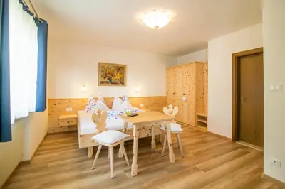 a dining room with a table and chairs at Garni Stübele in Tirolo