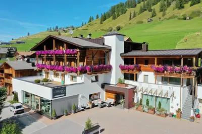 an overhead view of a building with flowers on balconies at Garni Jasmin in San Cassiano