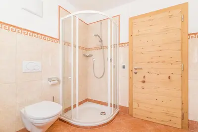 a hotel room with a bed and a couch at Garni Jasmin in San Cassiano