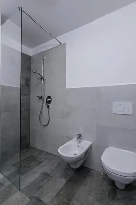 a bathroom with a shower and a toilet and a sink at Mair am Anger-Appartments in Riscone