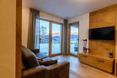 a living room with a couch and a television at Mair am Anger-Appartments in Riscone