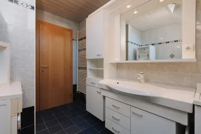 a bathroom with a sink and a mirror at Alpenvilla Large Family Apartment - by Familiaris- Pools 500 meters in Valdaora