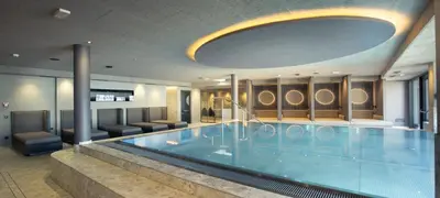 a large swimming pool in a hotel room at Alpenvilla Large Family Apartment - by Familiaris- Pools 500 meters in Valdaora