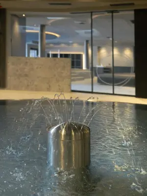 a fountain in a building with water spewing at Alpenvilla Large Family Apartment - by Familiaris- Pools 500 meters in Valdaora