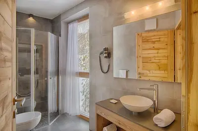 a bathroom with a sink and a shower at Hotel Garni Elisir in Arabba