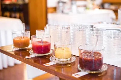 a group of glasses filled with different colored liquids at NaturResidence Dolomitenhof in Siusi