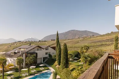 a view of a villa with a swimming pool and a vineyard at Appartement KroneLiving in Tirolo