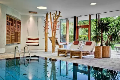 a house with a swimming pool with two chairs and a swing at Engels Park in Vipiteno