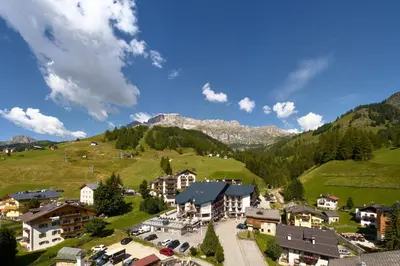 an aerial view of a village in the mountains at Hotel Portavescovo in Arabba