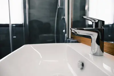 a bathroom sink with a faucet on top of it at Gasthof Hotel Wöhrmaurer in Feldthurns