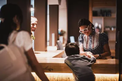 a woman and a child sitting at a table at Garberhof Dolomit Family in Rasùn di Sotto