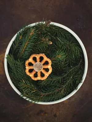 a bowl with a christmasreath with a cookie on it at Garberhof Dolomit Family in Rasùn di Sotto