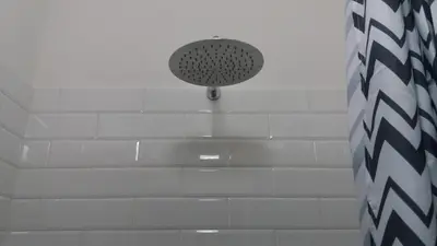 a shower with a shower head in a bathroom at La casa di Cì-CÌ in Merano