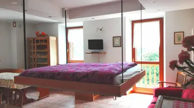 a bedroom with a canopy bed and a tv at Residenza Domino in Selva di Cadore
