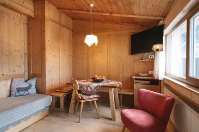 a small room with a table and a bed at Apartments Heritage House Margherita in Santa Cristina in Val Gardena