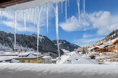 a group of icicles hanging from the roof of a building at Apartments Heritage House Margherita in Santa Cristina in Val Gardena