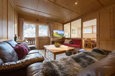 a living room with a couch and a table at Apartments Heritage House Margherita in Santa Cristina in Val Gardena