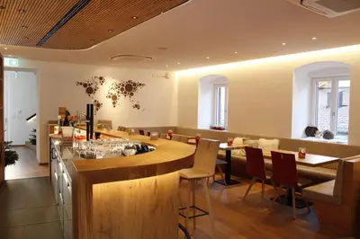 a restaurant with a bar with chairs and tables at Gasthof Zum Hirschen Margreid in Magrè allʼ Adige