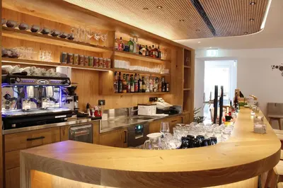 a kitchen with a bar with wine glasses at Gasthof Zum Hirschen Margreid in Magrè allʼ Adige