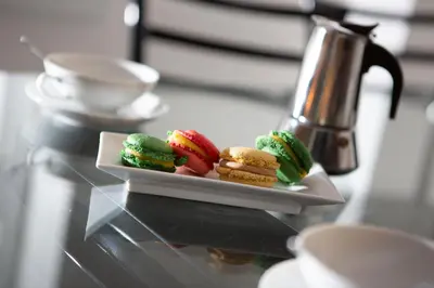 a plate of desserts on a table with a tea kettle at EDO in Campitello di Fassa