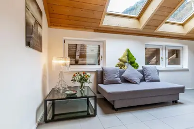 a living room with a couch and a table at EDO in Campitello di Fassa