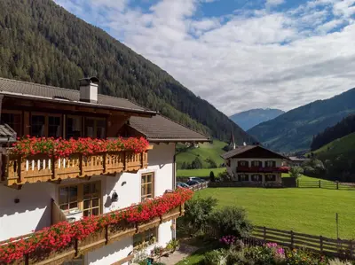 a building with flowers on the balcony of it at Sennerhof in Racines