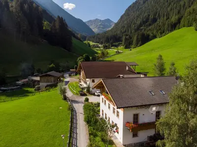 an aerial view of a house in a green valley at Sennerhof in Racines