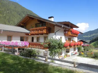 a building with flowers on the side of it at Sennerhof in Racines