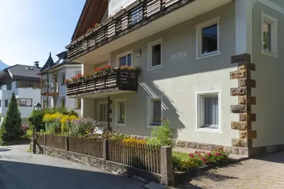 a building with flower boxes on the side of it at Apartments Jalve in Ortisei