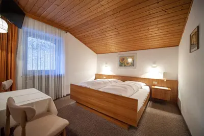 a bedroom with a large bed with a wooden ceiling at Alara in Bulla