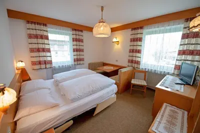 a bedroom with a bed and a desk with a computer at Alara in Bulla