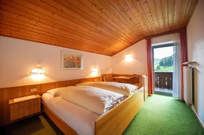 a bedroom with a large bed with a wooden ceiling at Alara in Bulla
