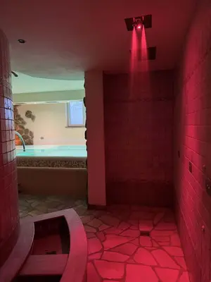 a bathroom with a tub and a red light at Villa Flora by AMA Val di Fassa in Canazei