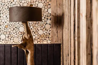 a wooden lamp with a tree branch as its head at ArtHotel Anterleghes - Gardenahotels in Selva di Val Gardena