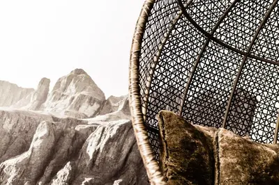 a chair with a picture of a mountain at ArtHotel Anterleghes - Gardenahotels in Selva di Val Gardena