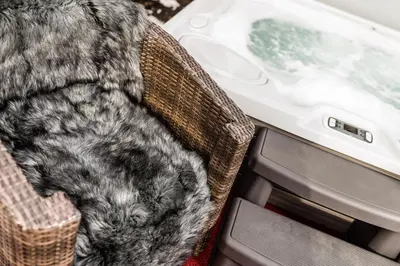 a cat sitting in a chair next to a table at ArtHotel Anterleghes - Gardenahotels in Selva di Val Gardena