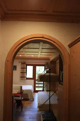 an archway in a room with a bedroom at Casa Focobon - presso Sussy residence in Falcade