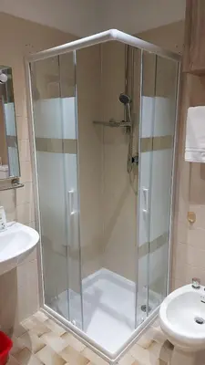 a shower with a glass door in a bathroom at Casa Focobon - presso Sussy residence in Falcade