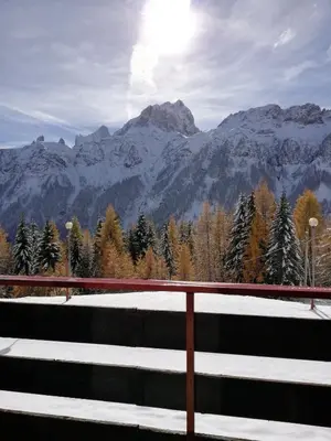 a view of a mountain range with snow on the ground at Casa Focobon - presso Sussy residence in Falcade