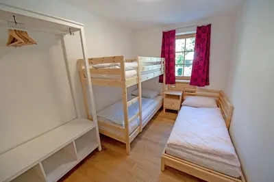 a room with two bunk beds and a window at Apartments Alpen Domus in Selva di Val Gardena