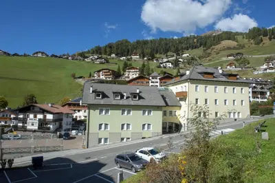 a view of a town with buildings and a street at Apartments Alpen Domus in Selva di Val Gardena