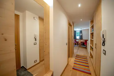 a hallway of a house with wooden walls at Apartments Alpen Domus in Selva di Val Gardena