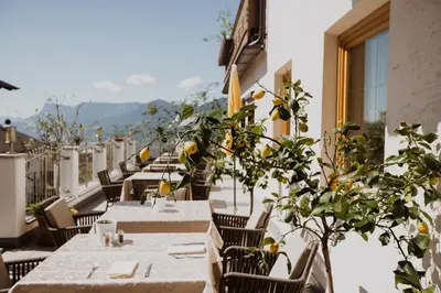 a row of tables and chairs on a balcony at B&B Hotel Mair am Turm in Tirolo