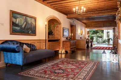 a living room with a couch and a rug at Romantik Hotel Oberwirt in Marlengo