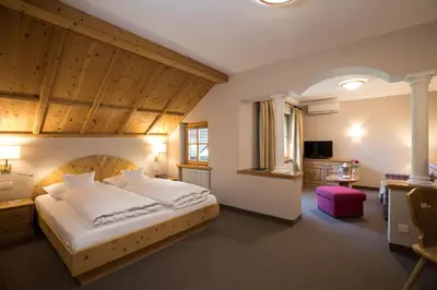a bedroom with a large bed in a room at Romantik Hotel Oberwirt in Marlengo