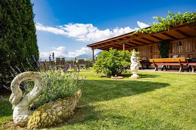 a garden with a statue in the grass at Hotel Stefanie in Tirolo